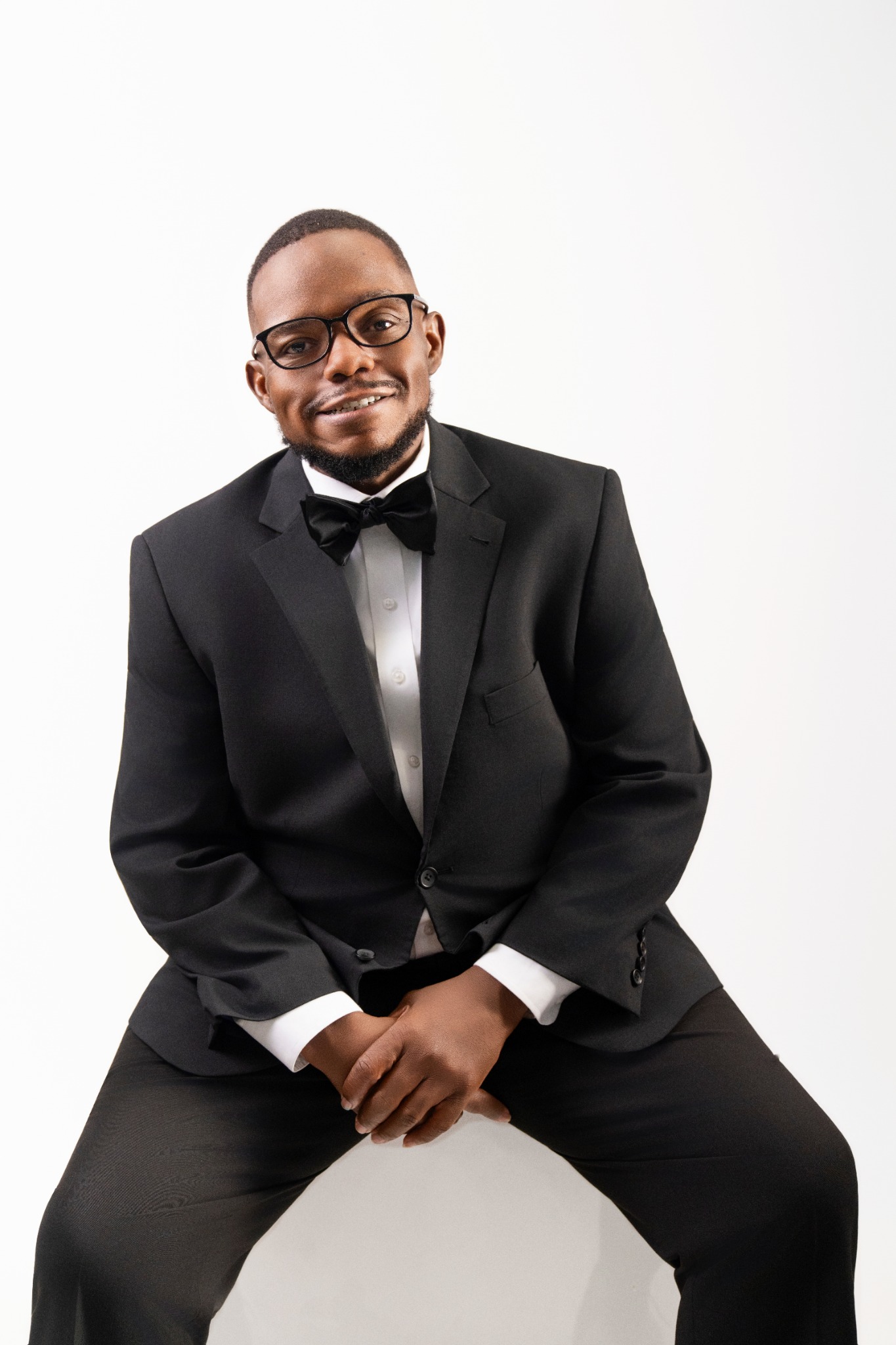 Jerome West seated in a black suit and bow tie